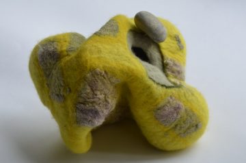Sculptural felt nestling stone